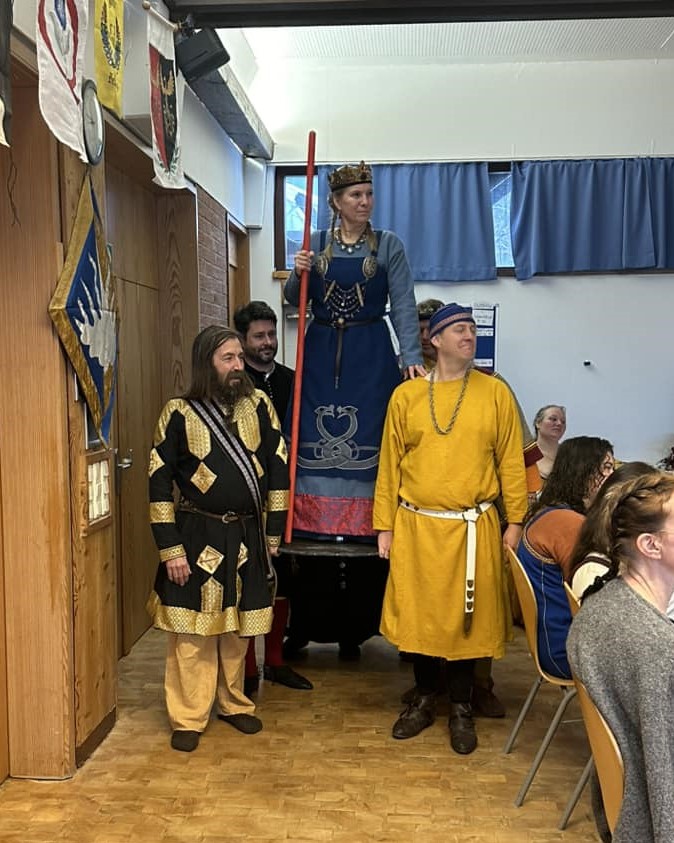 Lo is carried in on a shield